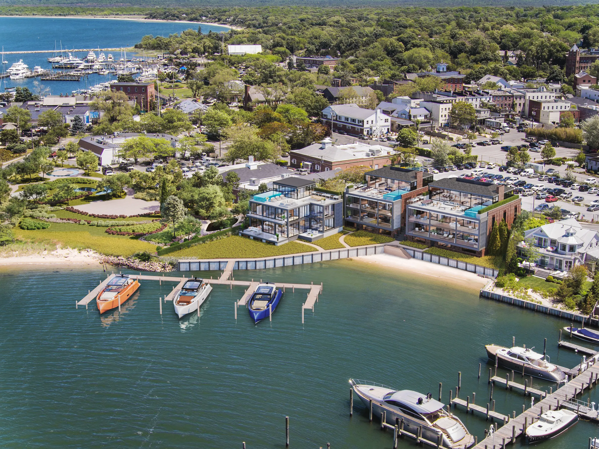 Aerial 3D rendering of 2 West Water Street on Sag Harbor Cove: three glass and brick residences behind a bulkhead and private docks with boats, the village and its marina beyond