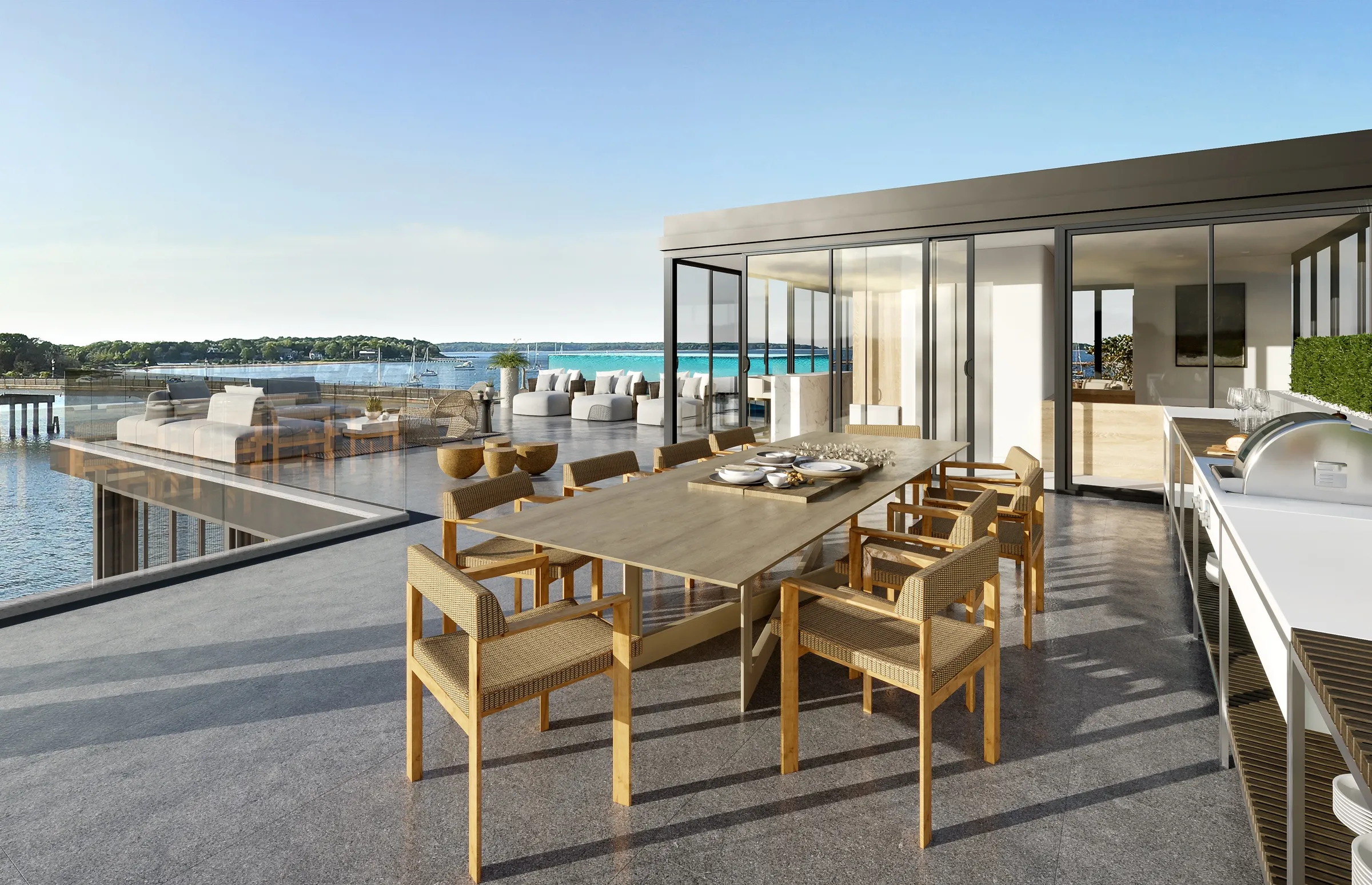 3D rendering of the Residence C rooftop deck at 2 West Water Street, Sag Harbor: a teak dining table and outdoor kitchen beside a glass pavilion, with lounge seating and the cove beyond a glass railing