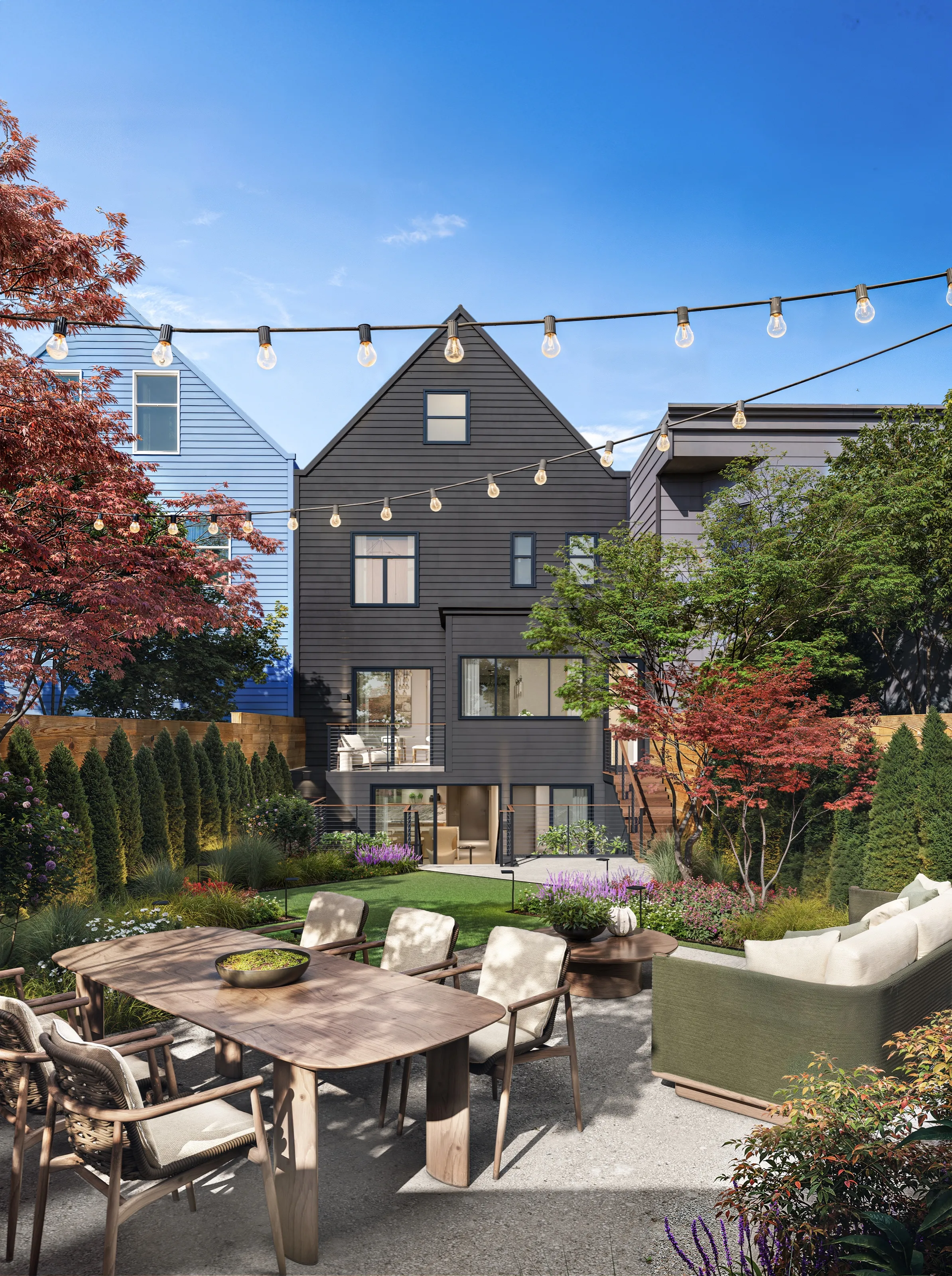 Daytime 3D rendering of the rear of 3740 Sacramento Street, a five-bedroom designer residence in Pacific Heights, San Francisco, its dark charcoal-shingled back facade above a landscaped garden with a dining table, an outdoor sofa, Japanese maples, and string lights.