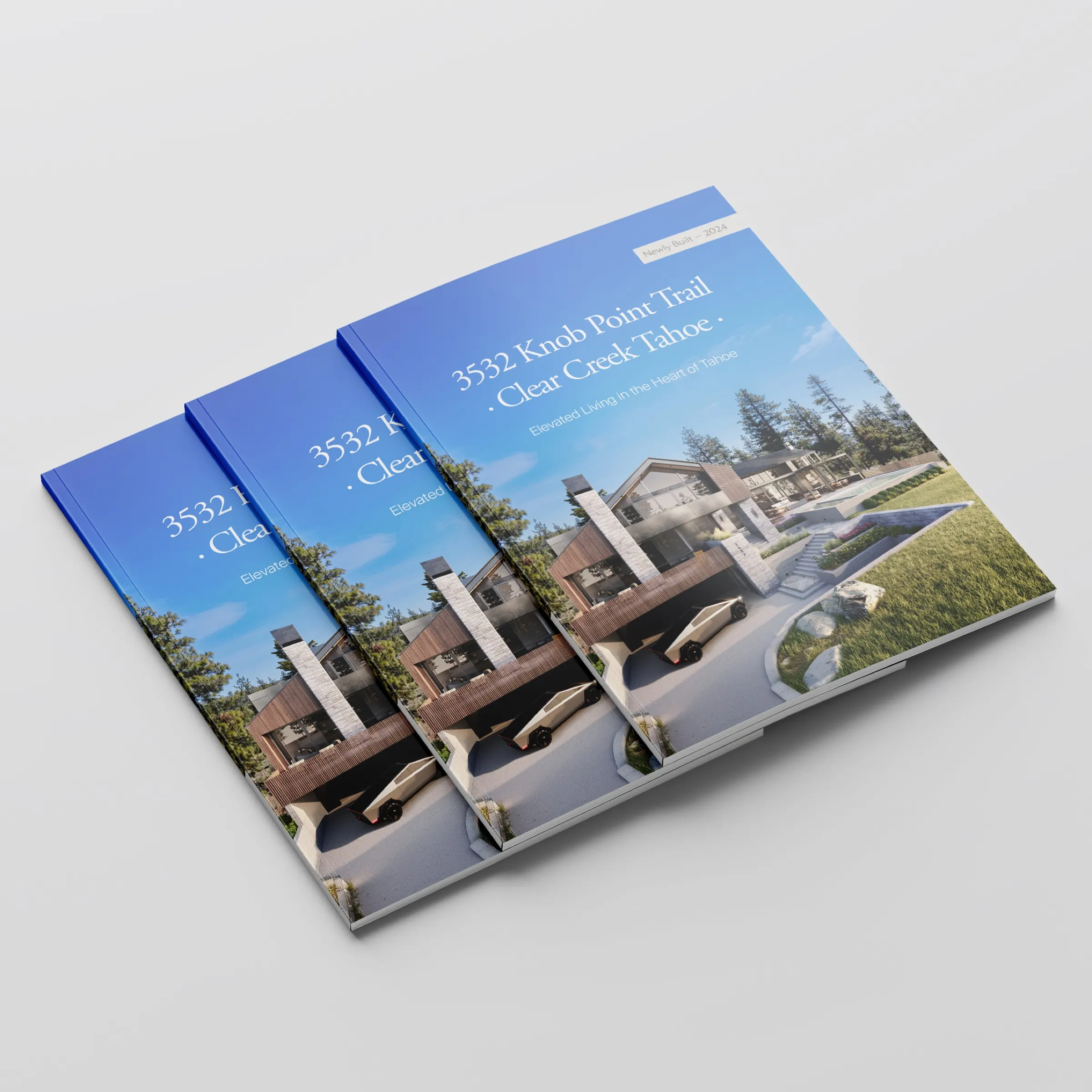 Printed sales brochures for 3532 Knob Point Trail, Clear Creek Tahoe, with the front exterior 3D rendering of the mountain-modern home on the cover.