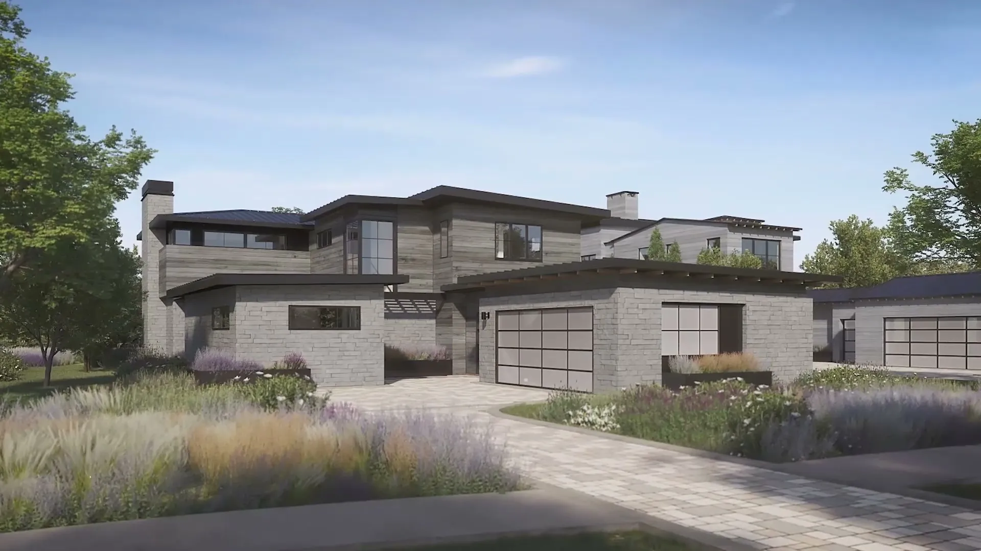 3D exterior rendering of a two-story ranch cabin at the Driftwood golf community near Austin, Texas, in grey stone and weathered timber, with a double garage, a paver drive, and lavender and native grasses in front.