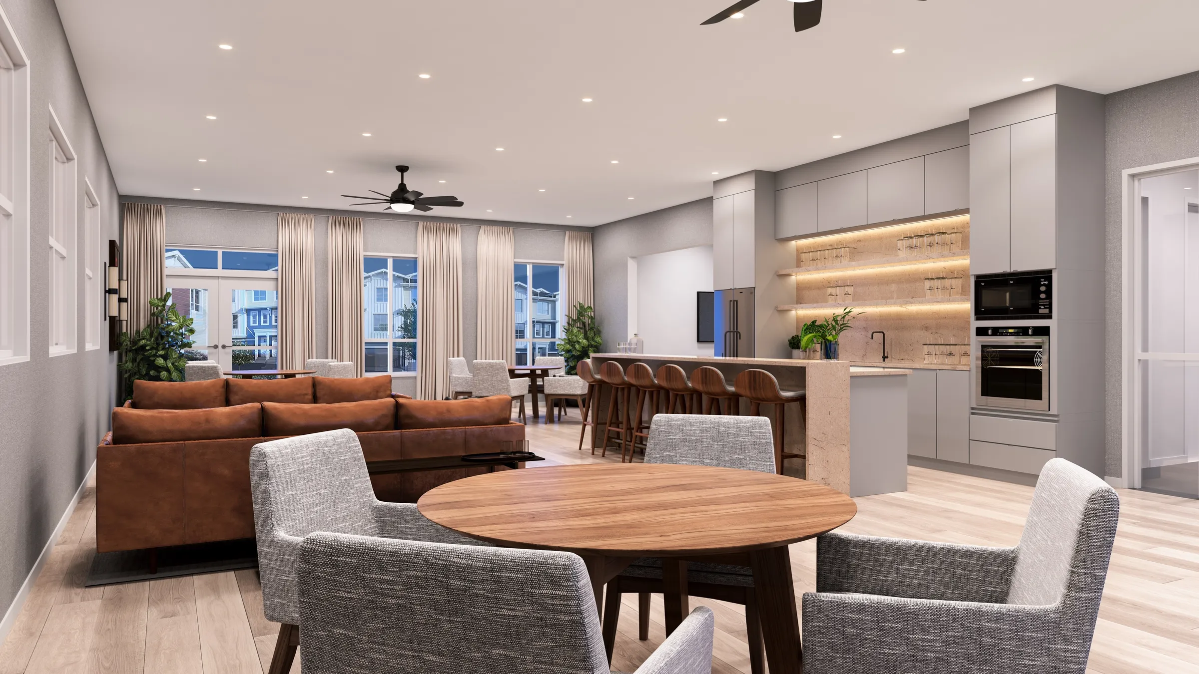 3D interior rendering by NoTriangle Studio of the lounge in the Hazelwood Club amenity building in South Surrey, BC: a round walnut table with grey chairs, a cognac leather sectional, a kitchen with a stone island, wooden bar stools and lit glass shelves, and tall curtained windows and French doors looking out to the townhomes.