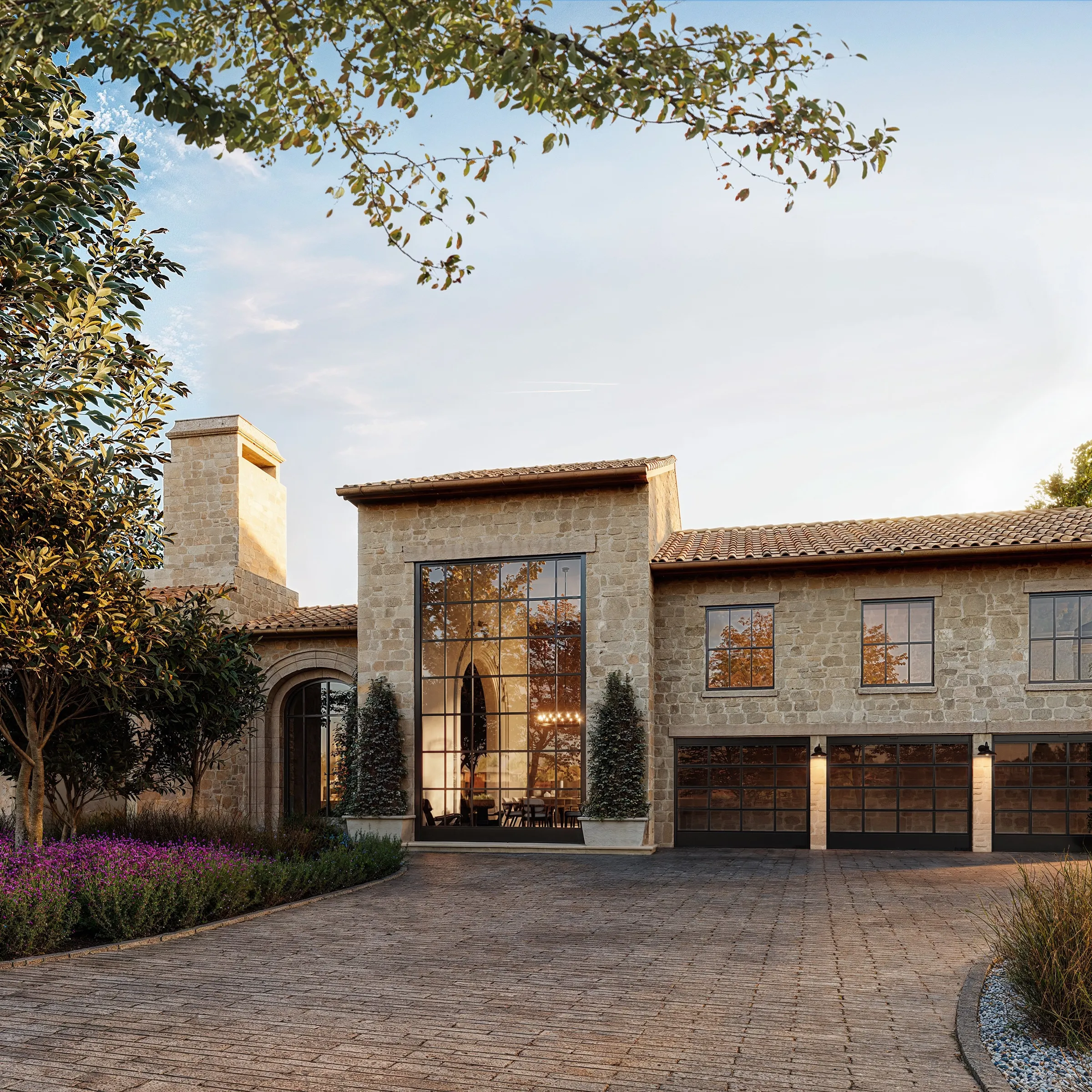 Exterior 3D rendering of a Hill Country style stone home with a tall glass entry, clay tile roofs, wood garage doors and lavender beds