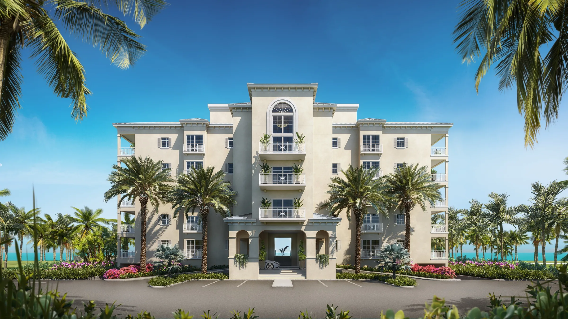 3D rendering of the front elevation of a beachfront condominium resort in Turks and Caicos, a five-storey cream building framed by palms with the ocean visible through its central archway.