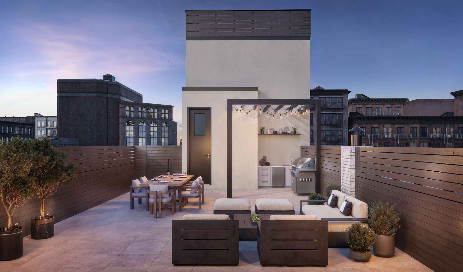 3D rendering of the roof deck at The Willow in Manhattan at dusk, with an outdoor dining table, lounge seating, a grill under a pergola strung with lights, a wood privacy screen, and surrounding rooftops.