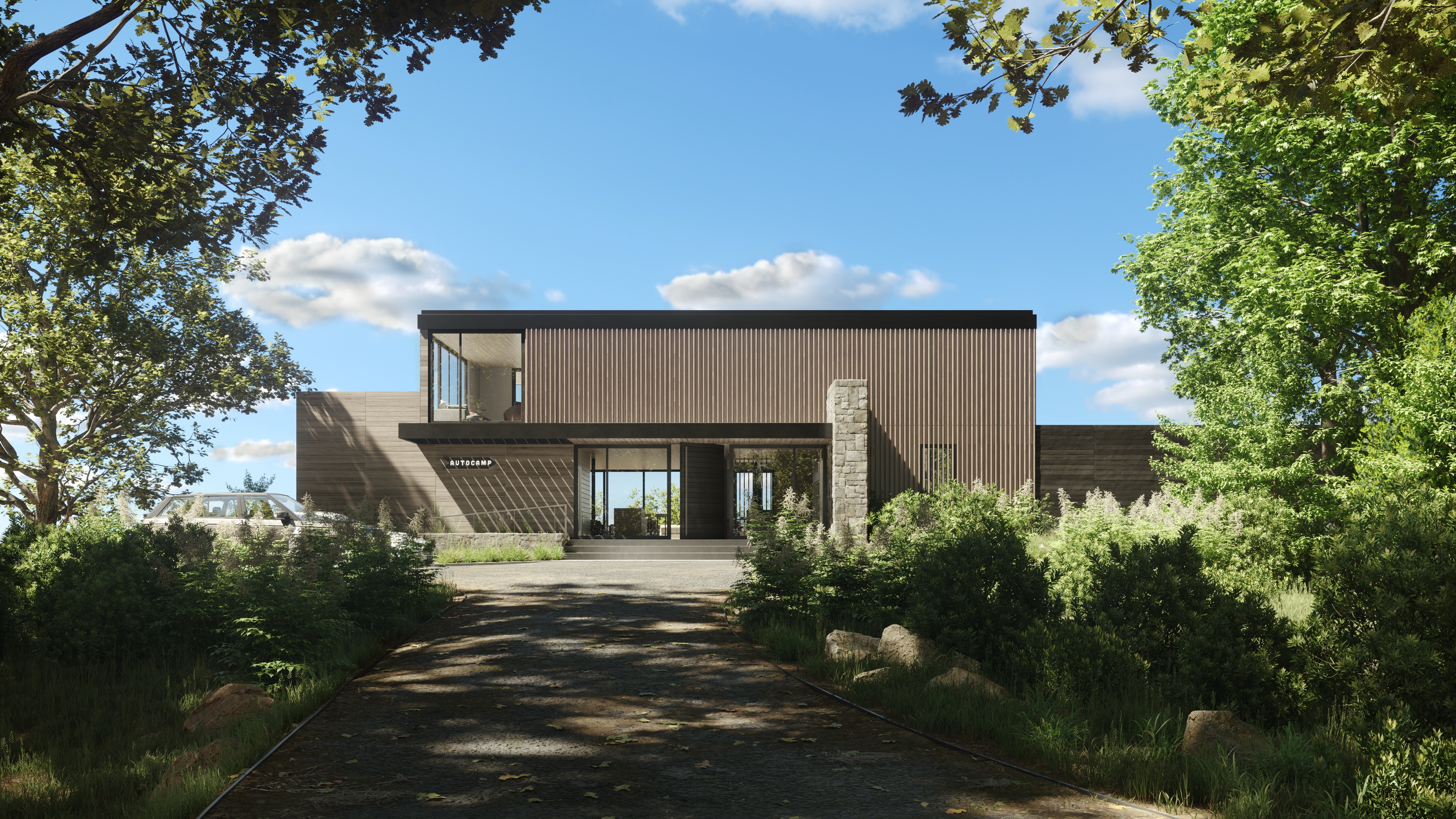 Daytime 3D rendering of the AutoCamp Cape Cod clubhouse seen from the gravel arrival drive, a vertical cedar-clad building with a stone pier and an AUTOCAMP sign, framed by trees under a blue sky.
