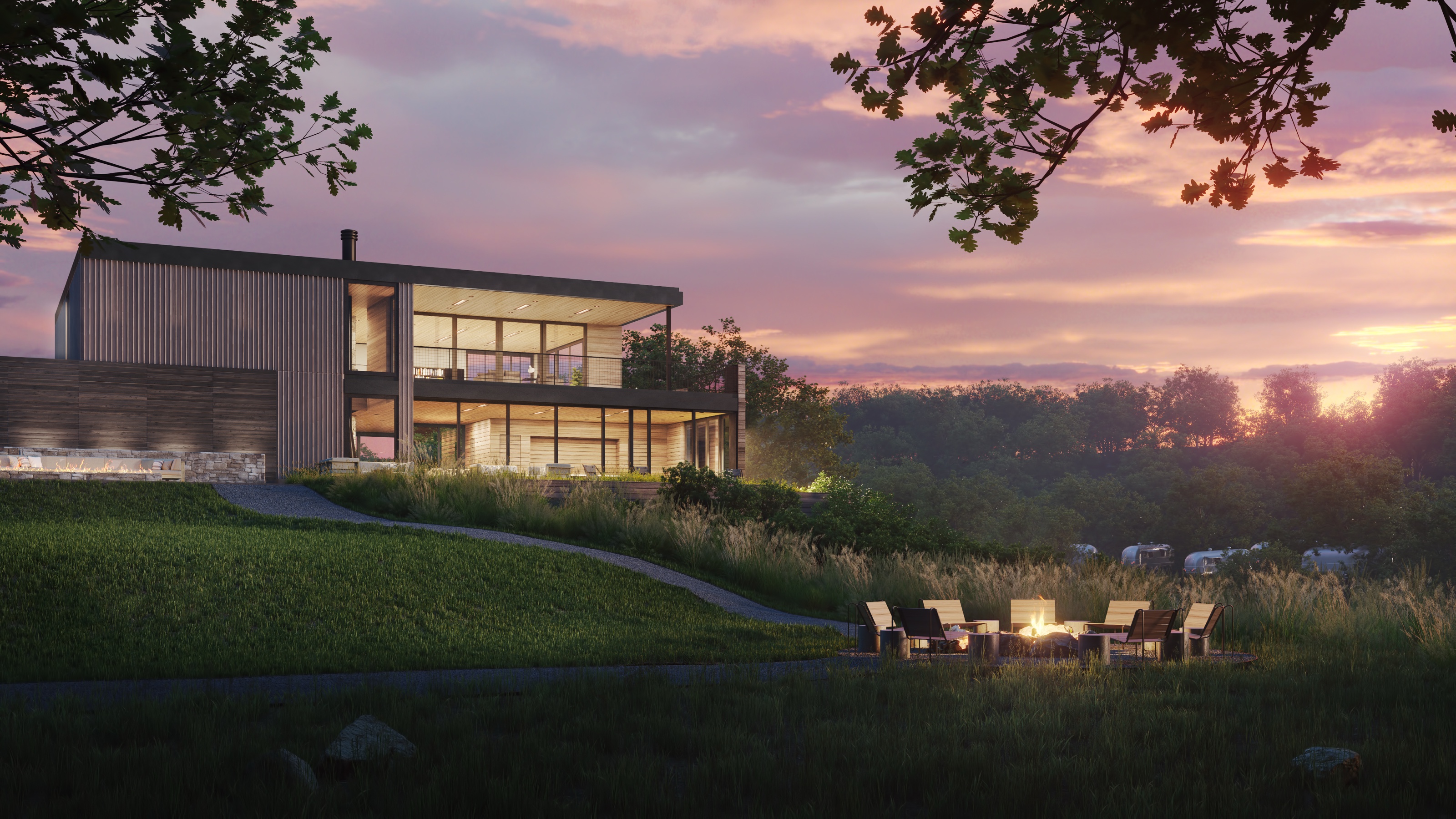 Dusk 3D rendering of the AutoCamp Cape Cod clubhouse glowing on a coastal rise above a firepit lounge, with Airstreams in the distance under a pink sunset sky.