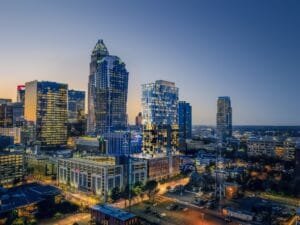 Cityscape 3D visualization of modern skyscrapers at dusk, produced using architectural rendering services